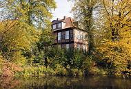 1771_9296 Historisches Herrenhaus im Hamburger Stadtteil Wohldorf Ohlstedt - das Fachwerk-Gebude wurde 1713 fertig gestellt. Bume und Strucher stehen am Ufer des Teichs; die ste mit Herbstlaub hngen dicht ber dem Wasser.