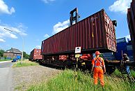 011_15723 Beladung eines Gterzugs mit Containern im Hafengebiet Hamburgs - ein Portalhubwagen holt den Container vom Lager und senkt ihn vorsichtig auf den Gterwaggon. Nachdem der Container seine Platz gefunden hat, fhrt die Lokomotive den Gterzug einen Waggon vor, damit der nchste leere Wagen beladen werden kann. Hafenarbeiter berwachen den Vorgang.