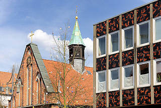 3363 Dach und Glockenturm der Heiligen Geistkapelle in Uelzen - 1320 als Bestandteil des Heiligen Geist Hospitals erbaut. Rechts Fassade eines Geschäfsgebäude - Bürogbäudes, Achitekur der 1970er Jahre.